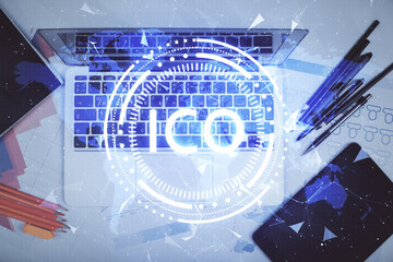 Blockchain theme hologram drawings over computer on the desktop background. Top view. Multi...