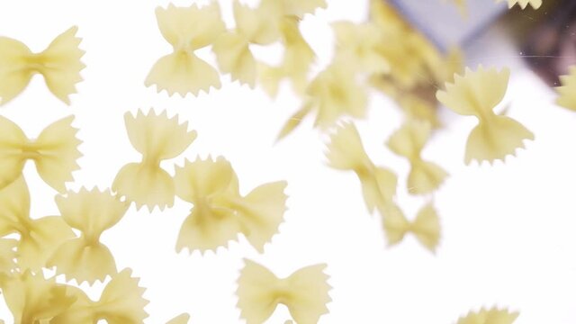 Pasta falling from package on a transparent background, filling the entire space, bottom view. Pasta fall to camera view. Cooking pasta concept. Pasta background