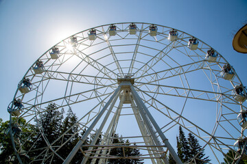 Ferris wheel in city park on a clear summer day