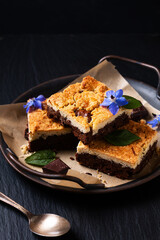 Food concept rustic Brookies or Crownies combine cookies and brownie on black background with copy space