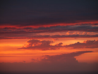 Beautiful burning clouds above the horizon during sunset