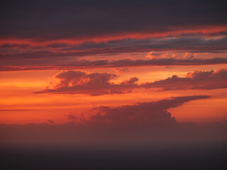 Beautiful burning clouds above the horizon during sunset