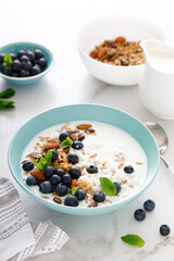 Blueberry and almond granola with greek yogurt, cottage cheese and fresh berries