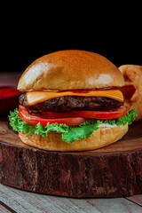 Hamburger on a wooden table with cheese.