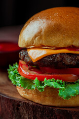 Hamburger on a wooden table with cheese.