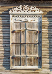 The window of an old Russian wooden house from the times of the Russian Empire.