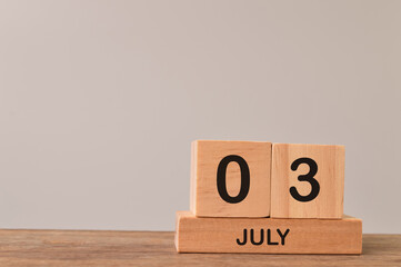 Wooden blocks calender for July 03 with empty space for the text.