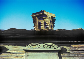 Part of the Facade with decor. Old Russian wooden house in an urban environment.