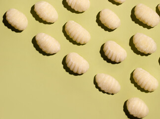 gnocchi blanks on a green background. Food pattern. Copy space
