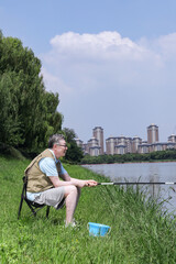 Fototapeta premium An old man was fishing by the lake
