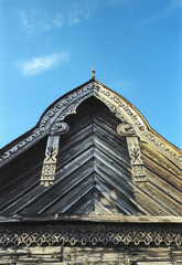 Pediment with decor. Part of an old Russian wooden house.