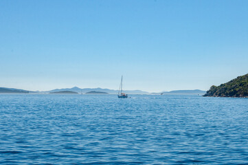 Boat floating over adriatic sea near Slano, Croatia during sunny summer morning, calm and relaxing view from boat trip.