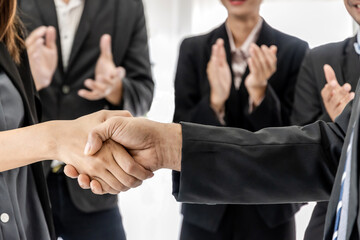 Congratulations. businessmen investor handshake while their colleague applauding in meeting room office, partnership, human resource solution, job promotion, cooperate business and teamwork concept