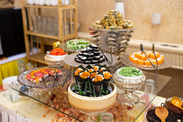 Japanese food rolls and sushi in restaurant at buffet