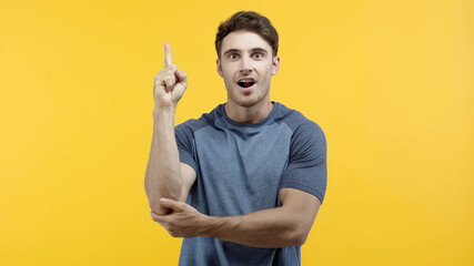 Amazed man having idea and looking at camera isolated on yellow