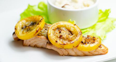 Grilled salmon fillet served with an exquisite salad consisting of cabbage, celery and apple with sultanas and roasted peanuts in mayonnaise