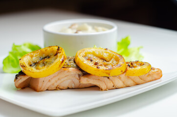 Grilled salmon fillet served with an exquisite salad consisting of cabbage, celery and apple with sultanas and roasted peanuts in mayonnaise
