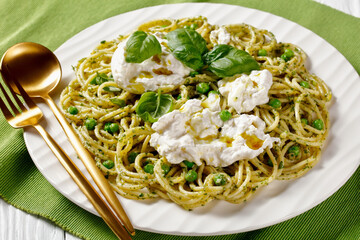 pesto spaghetti with green peas and burrata cheese