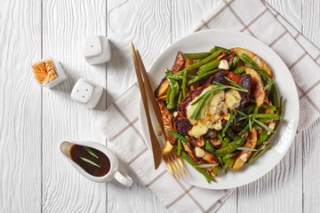 pork steaks topped with blue cheese and veggies