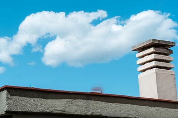Chimney of a house. Blue sky background with clouds