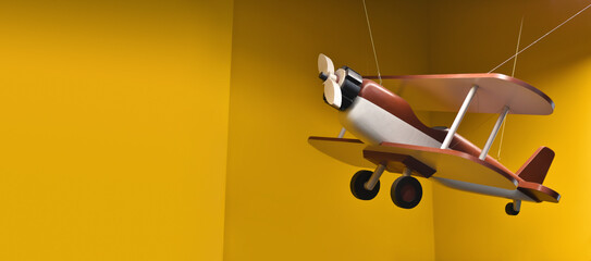 Travel by airplane. Wooden toy biplane hanging on ropes on yellow background