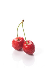 Red cherries with water droplets, close-up. Isolated on white background.