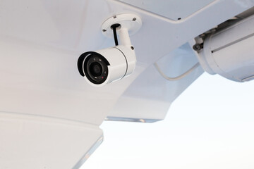 CCTV camera on the hull of an expensive motor yacht. CCTV camera white on a white body.