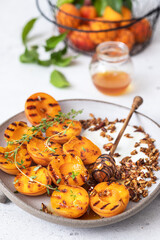 Grilled apricots with Greek yogurt, granola and honey. Summer breakfast