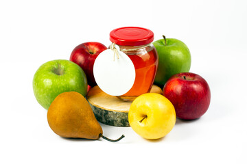 Homemade natural jam production concept. Transparent glass jar with jam inside on cross cut wooden logs, pear and various color apples isolated on white background. Part of set.