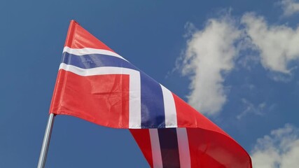 Norway. National country flag on blue sky background. Flying fabric symbol. Tourism or travel summer day. international patriotic emblem. Nobody. Horizontal video