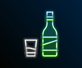 Glowing neon line Bottle of vodka with glass icon isolated on black background. Colorful outline concept. Vector