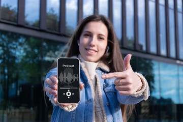 Podcast application. Audio podcast on mobile smartphone screen application in woman hand. Happy...