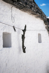 Alberobello, Puglia, Brindisi, Italy - july 19, 2017: View of the Famous village with typical dry stone Trulli houses and conical roof. Trulli picturesque street in the old town. Cone-roofed houses
