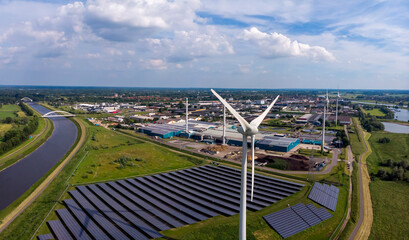 Panorama of wind turbines, water treatment and bio energy facility and solar panels part of...