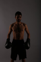 Fototapeta na wymiar Portrait of a boxer in the shadows