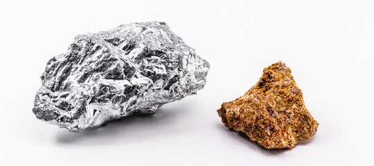 bauxite ore and aluminum stone together on isolated white background, industrial use ore.