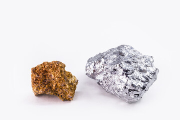bauxite ore and aluminum stone together on isolated white background, industrial use ore.