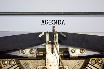 Business and agenda symbol. The concept word 'agenda' typed on retro typewriter. Beautiful white background. Business and agenda concept.