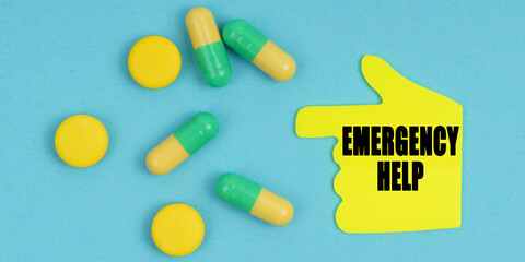 On a blue background, there are pills and a hand-sticker with the inscription - Emergency help