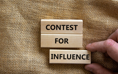 Contest for influence symbol. Wooden blocks with words 'Contest for influence'. Beautiful canvas background, businessman hand. Business, contest for influence concept, copy space.