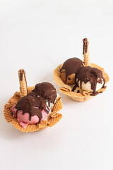 two little ice cream hats of different flavors, with a white background