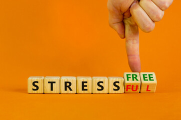 Stress free or stressful symbol. Businessman turns cubes, changes words 'stressful' to 'stress free'. Beautiful orange background. Medical, psychological, stress free or stressful concept. Copy space.