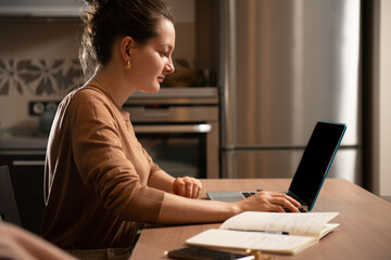 Caucasian woman using laptop at home