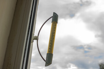 Outdoor thermometer on the window close up