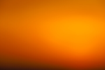 Blurred sunset sky. Abstract orange gradient color as a background