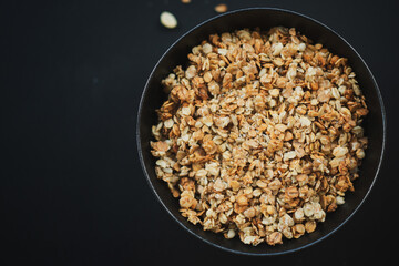 Homemade granola in bowl on dark