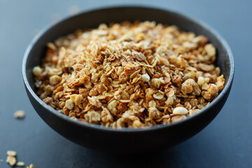 Homemade granola in bowl on dark