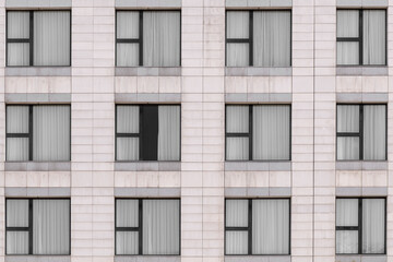 Fototapeta premium White marble granite facade and multiple windows closed