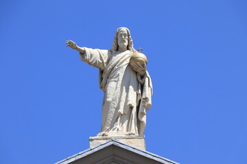 Fototapeta na wymiar Amsterdam Mozes en Aaronkerk Church Roof Detail with White Blessing Christ Statue