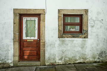 Door and window of an old building made of stone plastered with lime filled